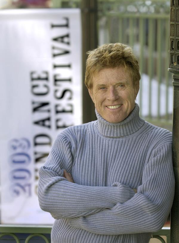 Robert Redford poses near one of his Sundance Film Festival banners on Jan. 17, 2003, in Park City, Utah.   (AP-Yonhap)