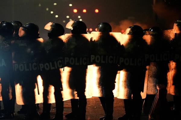 Police officers stand guard during a protest in Lima, Peru, Saturday. (Reuters-Yonhap)