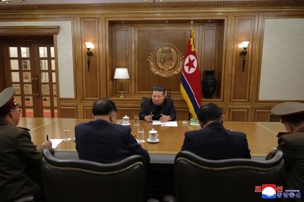 North Korean leader Kim Jong-un (C) presides over a key consultative meeting on the production of nuclear materials and weapons on Friday, in this photo carried by the North