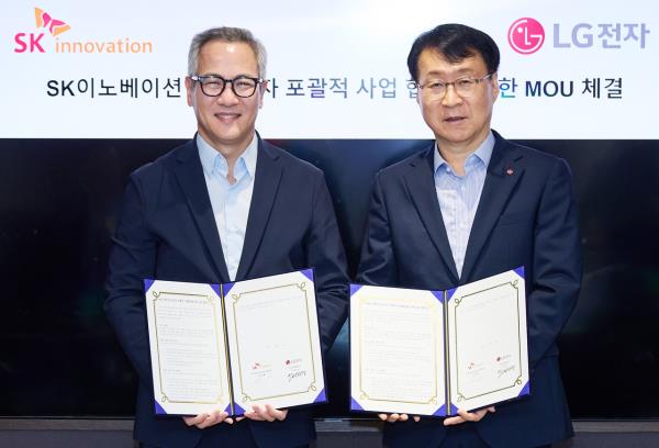 LG Electronics Vice President Lee Jae-sung (right) and Kim Moo-hwan, head of energy solutions at SK Innovation, pose during a signing ceremony in Seoul on Wednesday. (SK Innovation)