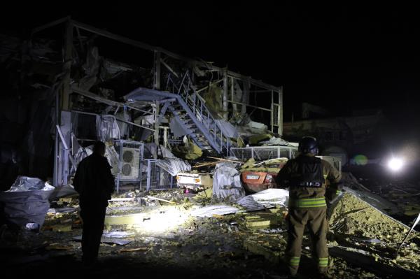 Rescuers work near a destroyed supermarket after a Russian drone strike in Zaporizhzhia, Ukraine, Saturday. (AP)