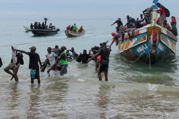 Migrants attempting Atlantic crossing disembark from a pirogue in Dakar, Senegal, Tuesday. (Reuters-Yonhap)