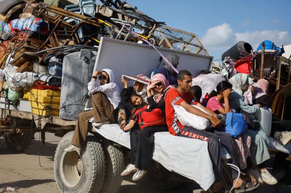 Displaced Palestinians, fleeing northern Gaza due to an Israeli military operation, move southward, using a vehicle packed with personal belongings, in the central Gaza Strip, Sunday. (Reuters-Yonhap)
