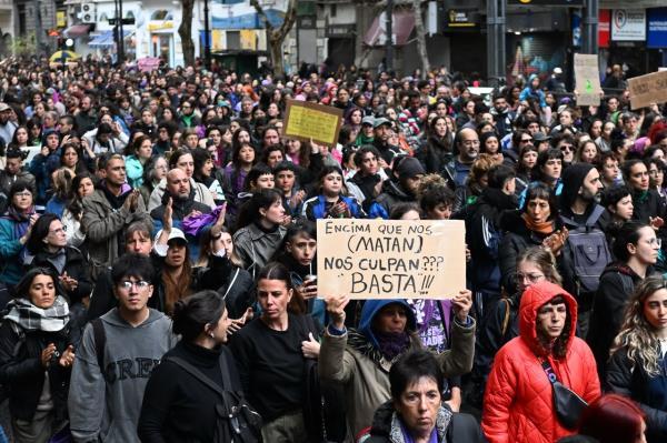 People attend a demonstration called by rights groups under the banner, "There are no good or bad victims, only femicides," referencing the three murdered teenager in Buenos Aires, Argentina, Saturday. (AFP-Yonhap)
