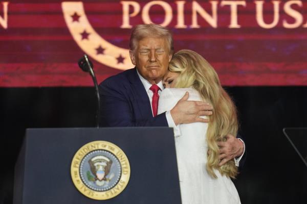 President Donald Trump (left) embraces Erika Kirk at a memorial for conservative activist Charlie Kirk at State Farm Stadium in Glendale, Arizona, on Sunday.   AP-Yonhap